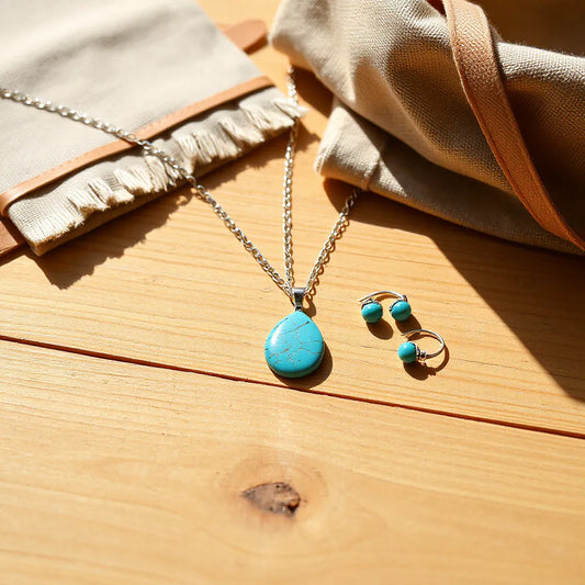 Turquoise bohemian southwestern jewelry set with necklace, earrings, and bracelet on a sunlit wooden surface