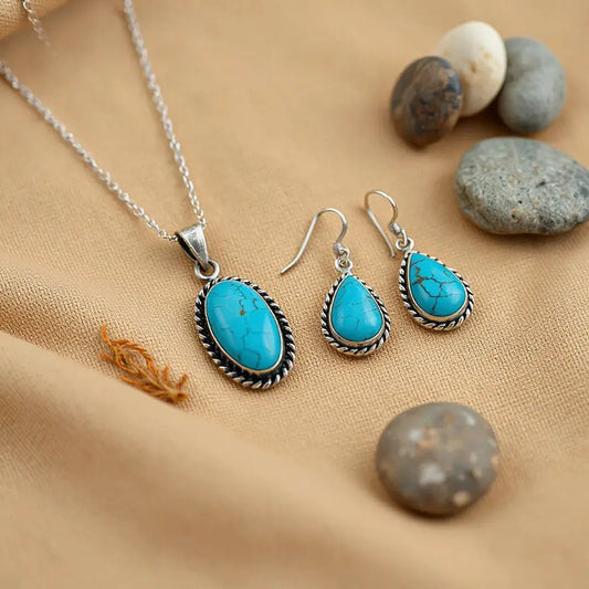 Turquoise and silver bohemian southwestern jewelry set on warm fabric with desert stones