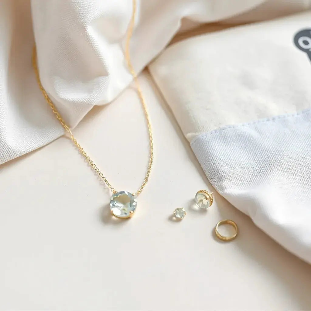 Refined gemstone necklace with matching earrings arranged neatly on a neutral surface in soft natural light