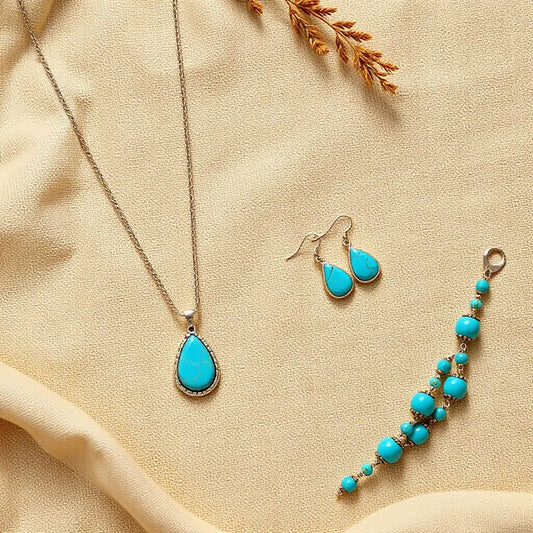 Turquoise bohemian southwestern jewelry set with necklace, earrings, and bracelet on neutral fabric