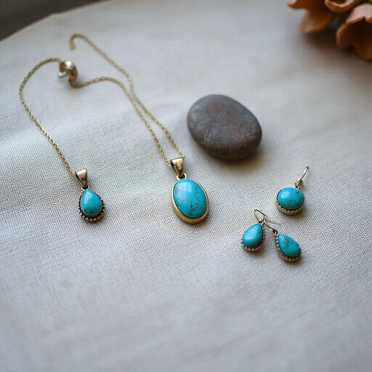Vintage turquoise pendant necklace, earrings, and ring with silver settings on neutral linen