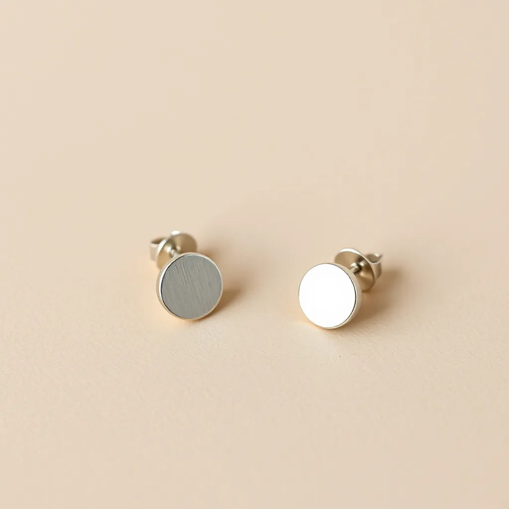 Pair of hypoallergenic earrings with visible ear-safe metal posts on a neutral studio background